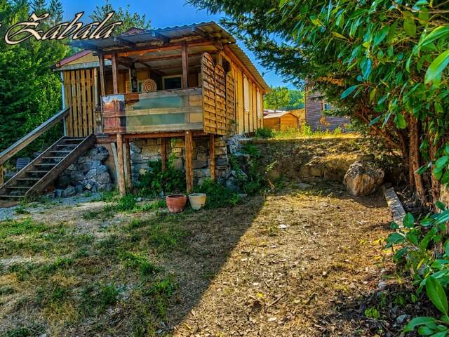 Bungalow en bois avec terrain privatif, terrasse et cave – PRL — photo du bien