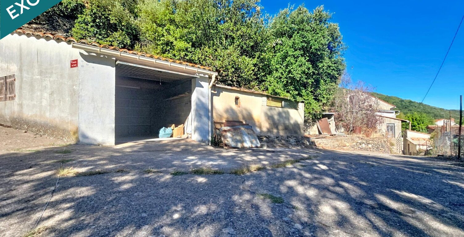 Une maison de village à fort potentiel, avec terrain en terrasses, vue dégagée et grand garage indépendant. — photo 1
